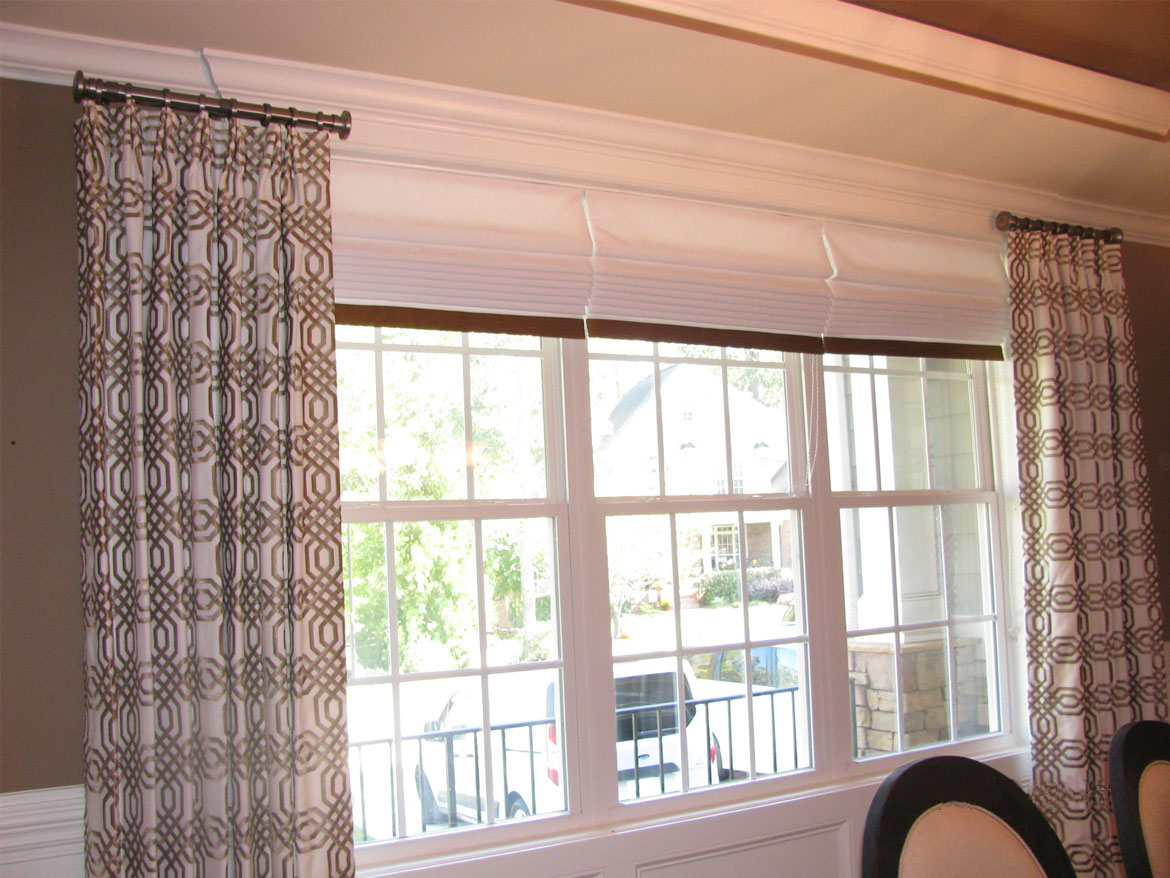 Dining room with drapes and shades