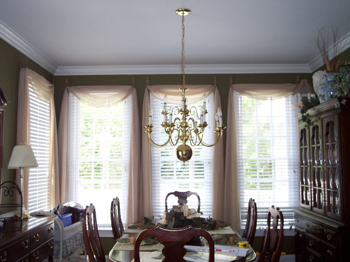 Dining room with sheer swags before
