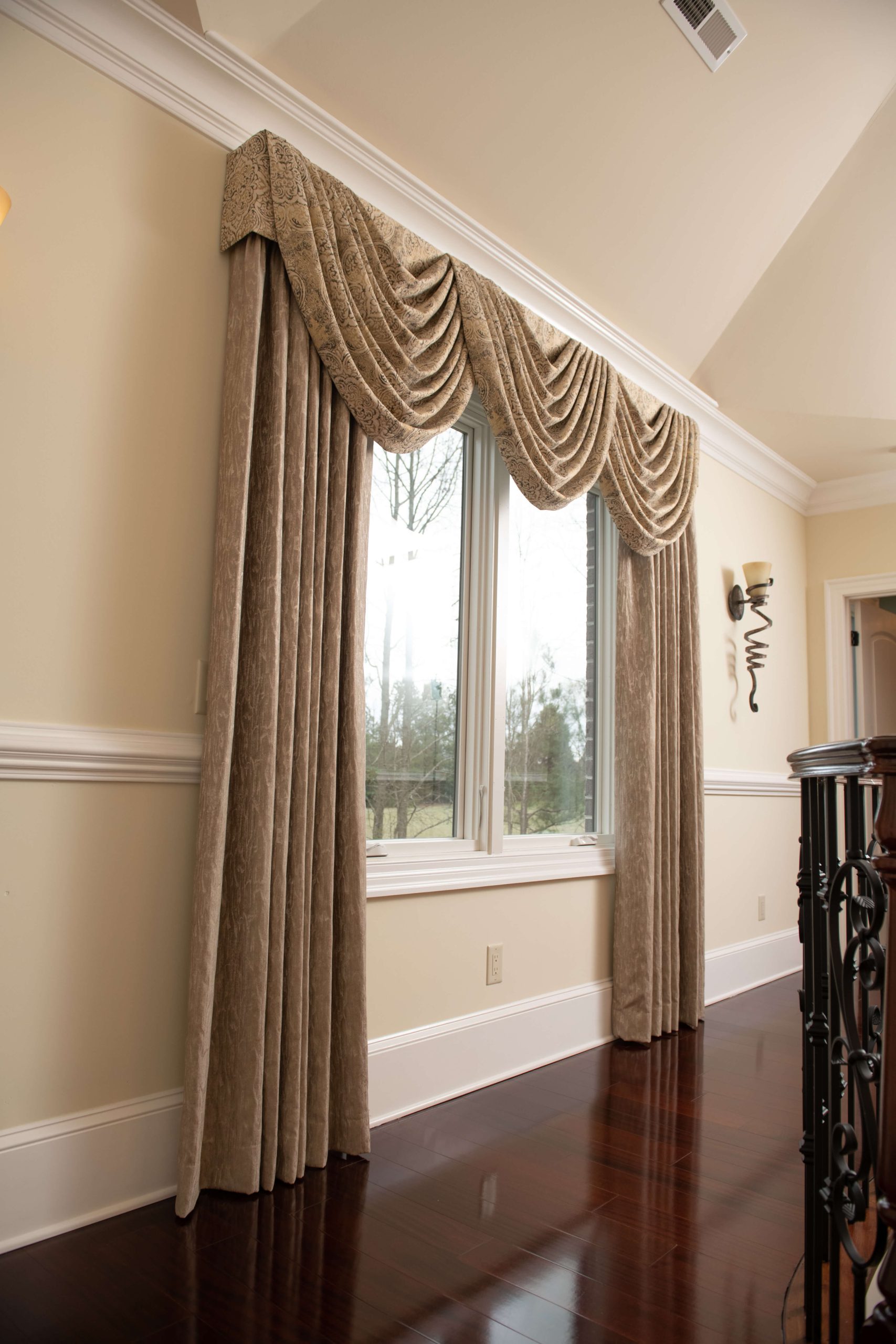 An image of a window with brown curtains.