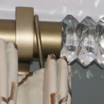 An elegant curtain finial on a curtain rod.